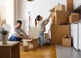 Careful packing of fragile items with bubble wrap and packing paper for safe moving